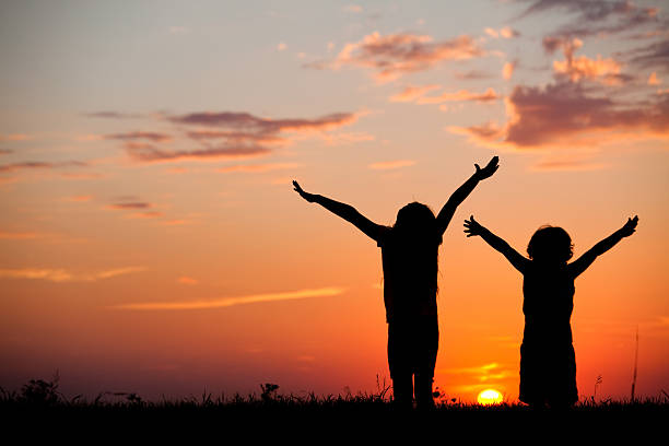 istock Silhouette of Kids Praising God 497268949