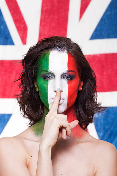 istock Italian supporter for FIFA 2014 making silence gesture during It 497270393