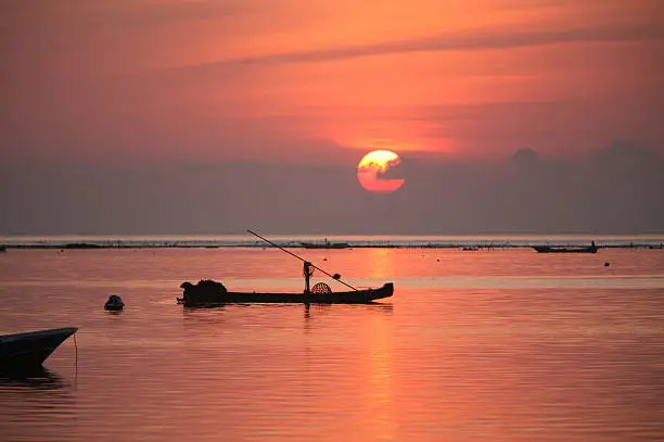 The coast with boats in the seagrass plantation on the island of Nusa Lembongan of the neighboring island of Bali, Indonesia.