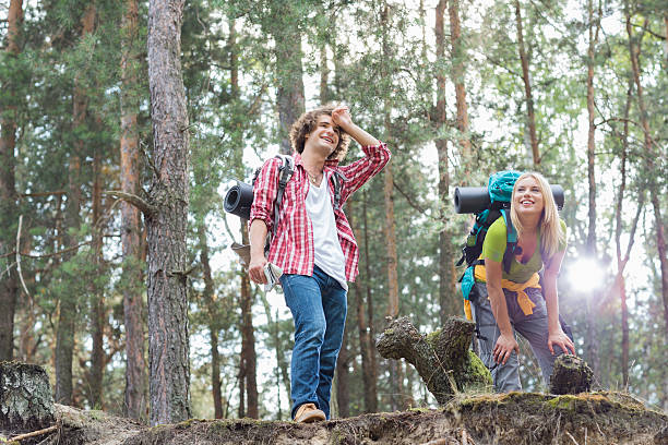 istock Tired young hiking couple taking a break in forest 497270811