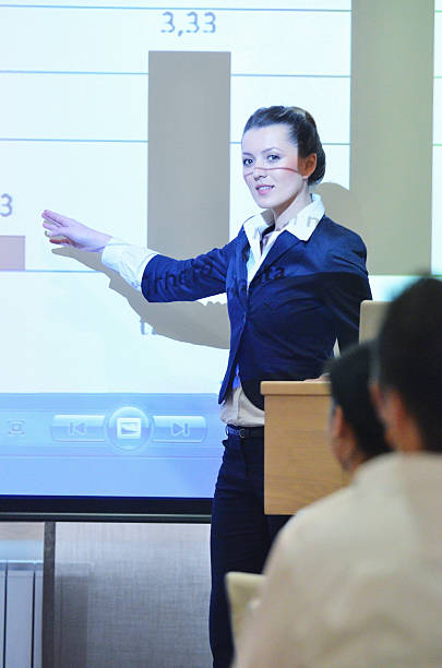 istock business woman giving presentation 497271707