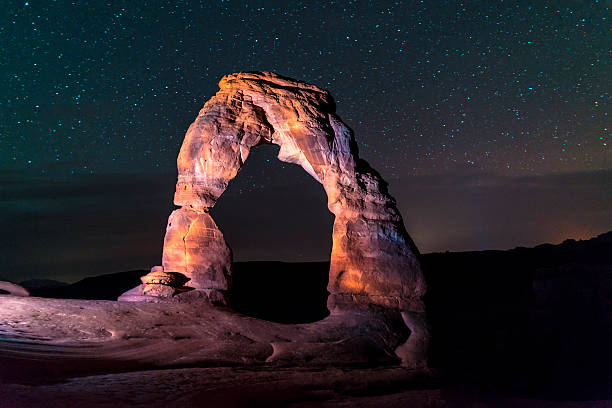 istock Delicate Arch at Night against Beautiful night sky 497273793