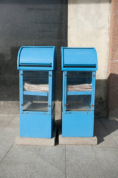 Blue newspaper dispensers on sidewalk Blue newspaper dispensers on sidewalk; Tallinn; Estonia; Europe paper dispenser stock pictures, royalty-free photos & images