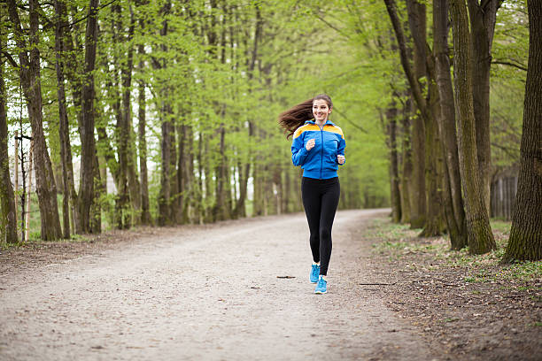 istock Young beautiful woman running on a trail 497275038