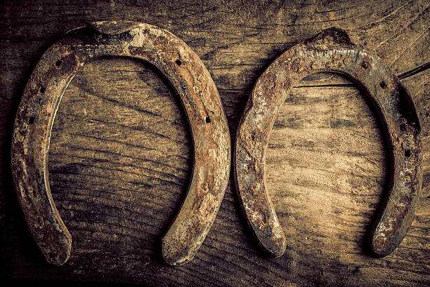 istock horseshoe on old wood background 497275424