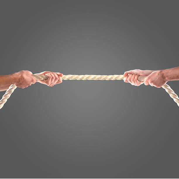 istock Hands of people pulling the rope on black background 497276932