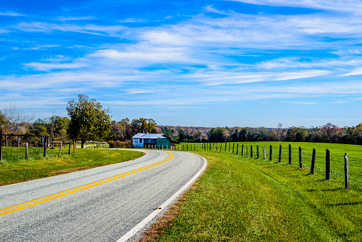 A rural highway in the farmlands of North Carolina captured during fall season.