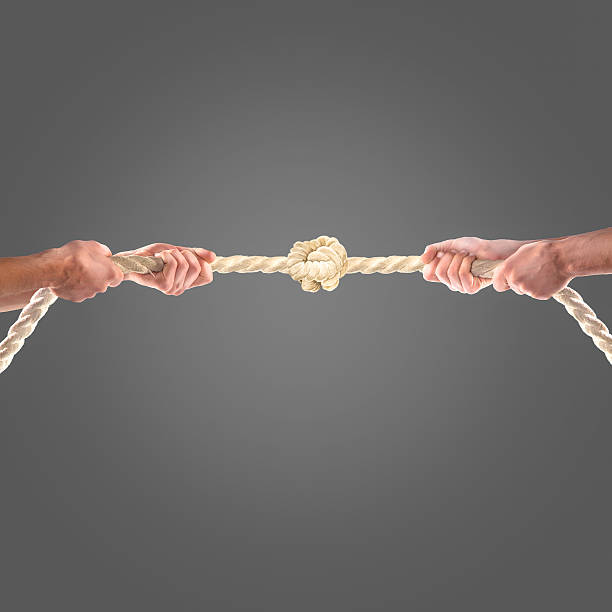 istock Hands of people pulling the rope on black background. 497277598