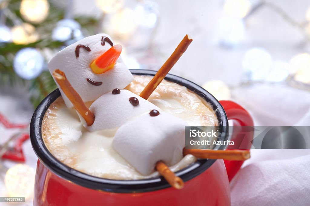 Hot chocolate with melted snowman Red mug with hot chocolate with melted marshmallow snowman Christmas Stock Photo