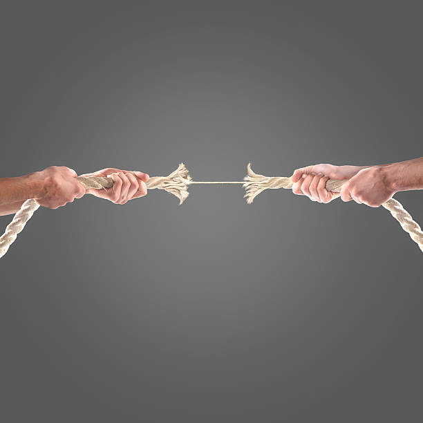 istock Hands of people pulling the rope on black background. 497278008