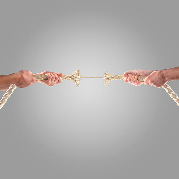 istock Hands of people pulling the rope on a gray background. 497278184