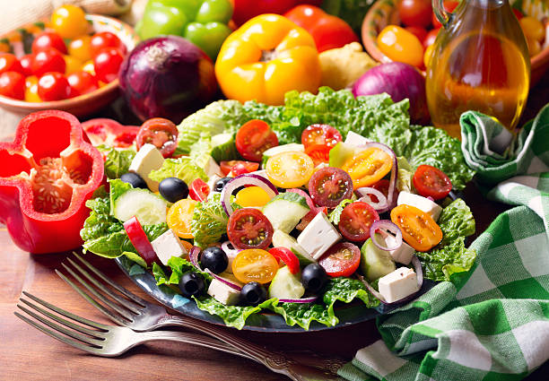 plate of greek salad plate of greek salad on wooden table mediterranean food photos stock pictures, royalty-free photos & images