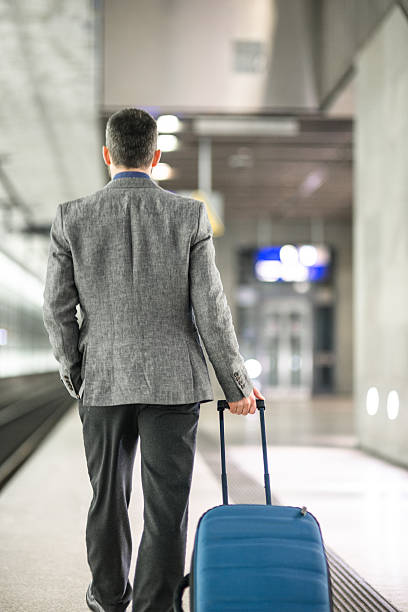 istock businessman walking on the train platform at the station 497278964