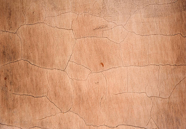 istock Texture of old wall covered with brown stucco 497279690