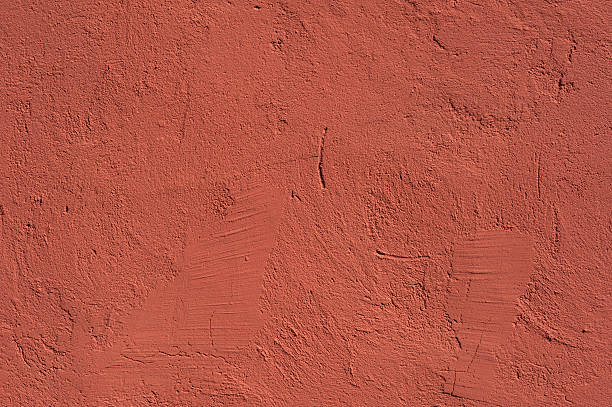 istock Texture of old wall covered with red stucco 497279836