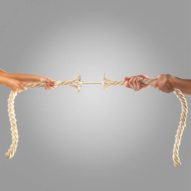 istock Hands of people pulling the rope on a gray background. 497280200