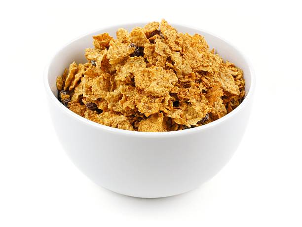 Bowl of bran flake cereal Bowl of bran flakes cereal on a white background bran flakes stock pictures, royalty-free photos & images