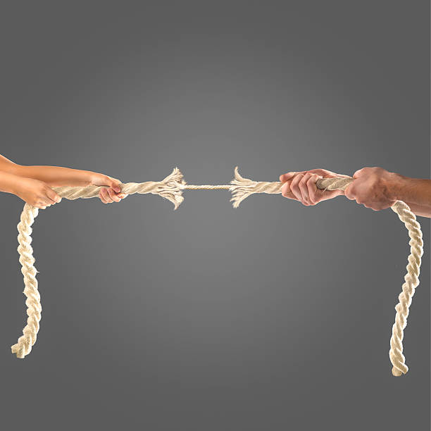istock Hands of people pulling the rope on black background 497280420