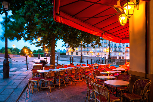 Colorful tables and chairs in sidewalk cafe