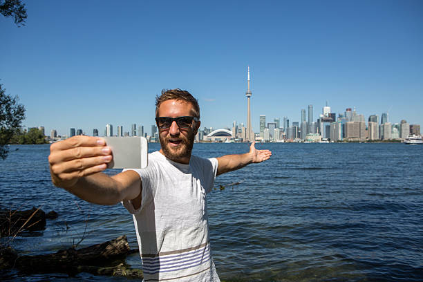 istock Young cheerful man in Toronto-Canada taking a selfie portrait 497281200