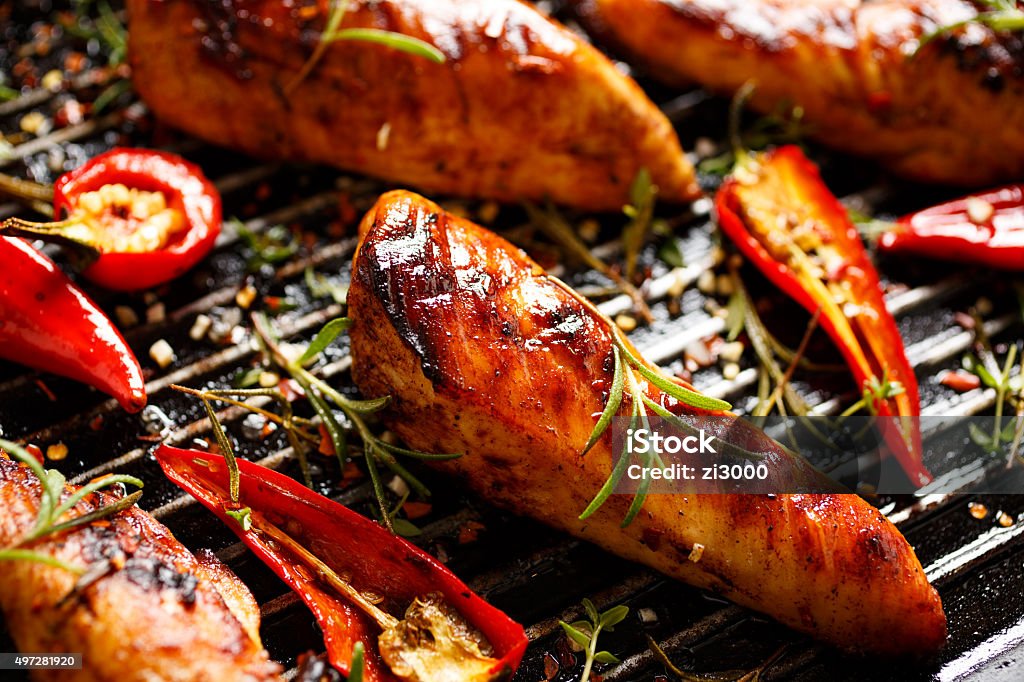 Grilled fillets of chicken in spicy marinade Spicy grilled chicken breast with the addition of chili and rosemary. Delicious and nutritious dish with grilled. 2015 Stock Photo