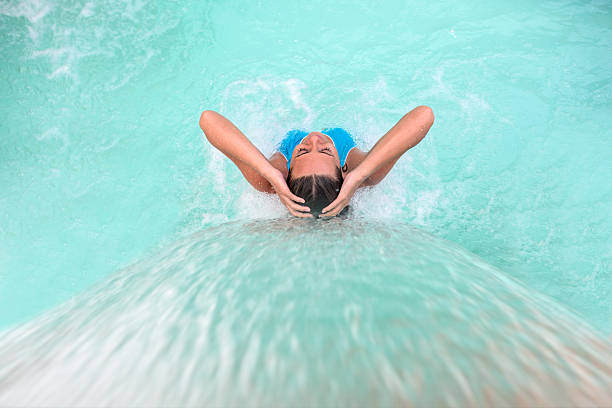 Woman relaxing at the spa Beautiful woman relaxing at the spa in the swimming pool under a stream of water health farm stock pictures, royalty-free photos & images