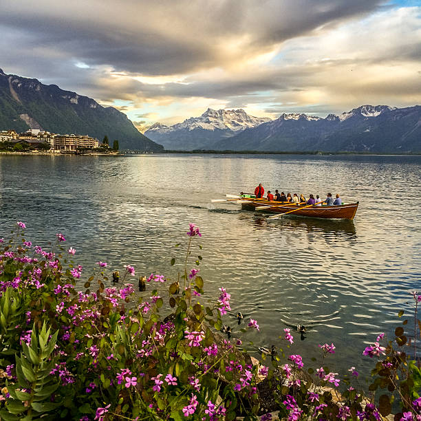 Montreux, Switzerland  - May 8, 2014: Group of people kayaking on Lake Geneva in the evening, Montreux