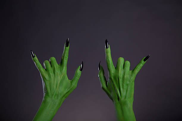 istock Green monster hands showing heavy metal gesture 497284044