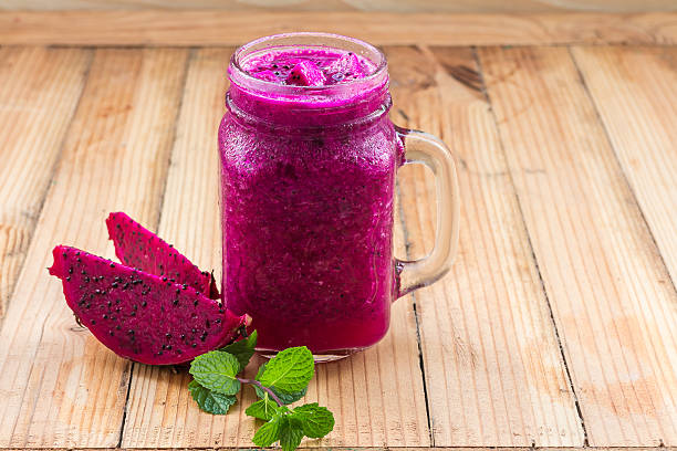istock Smoothie dragon fruit in mason jar on wood background 497284632