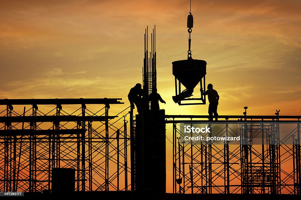 silhouette of construction worker on construction site Construction Site Stock Photo