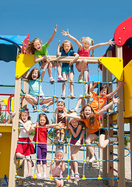 Happy kids playing outdoors stock photo