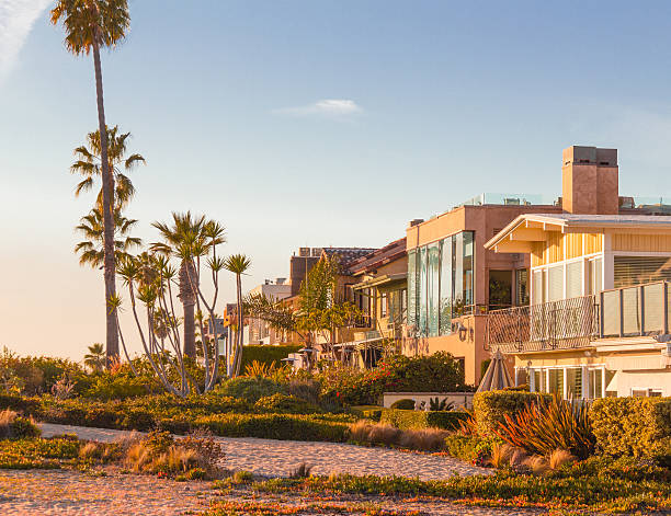 California's Balboa Islands Beach Houses (P) Beach Houses line the sandy beach of Balboa Island at Newport Beach, Southern California in the USA. newport beach stock pictures, royalty-free photos & images