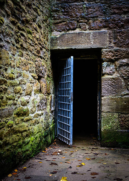 Opened prison door Opened prison door in an old castle dungeon medieval prison prison cell stock pictures, royalty-free photos & images
