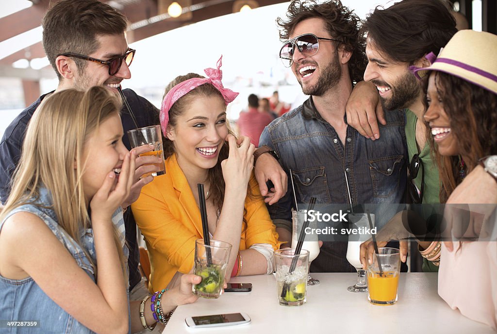 Friends having fun at the bar. Friends having fun at the bar outdoors, drinking cocktails. 20-29 Years Stock Photo