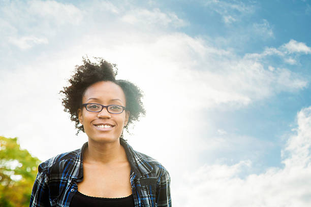 istock Young happy confident smart black female smiling with sky 497288136