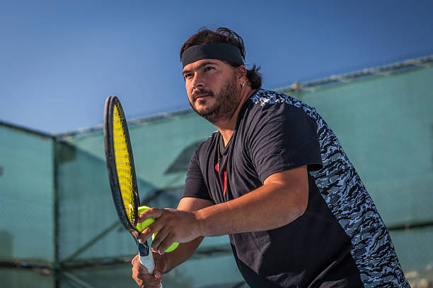 istock man playing tennis  match 497288158