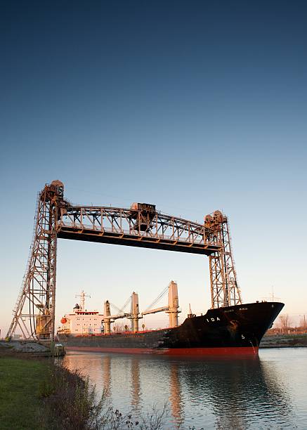 St. Catharines, Ontarion, Canada - November 15, 2015: The Ida Bulk Carrier bathed in the late evening sunlight while passing under the Glendale Road lift bridge, navigating south up the Welland Canal 