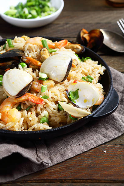 istock Rice with shrimp and mussels in a frying pan 497288482