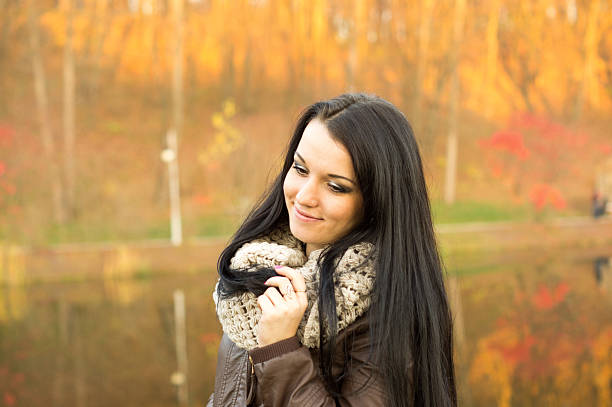 istock Young pretty woman in autumn park 497297121