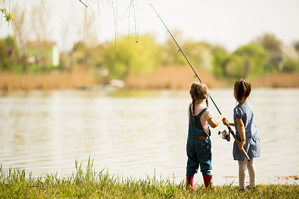 Two little girls fishing stock photo