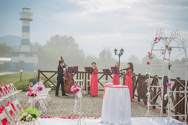 Quartet of classical musicians playing at a wedding stock photo