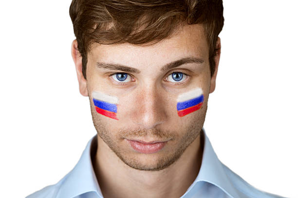 istock footbal fan with russian flag painted at the face 497300785