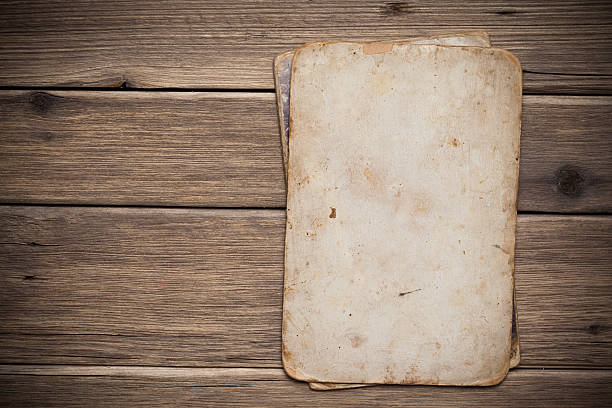 istock Old paper on the wood background 497301229