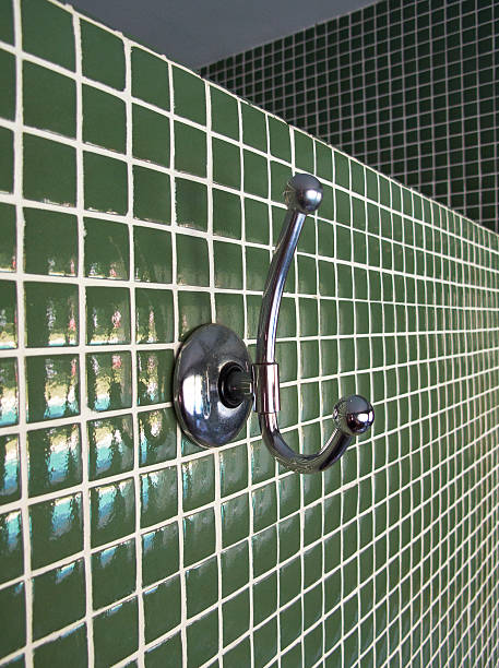 istock Metallic cloth hanger on a green wall 497304033