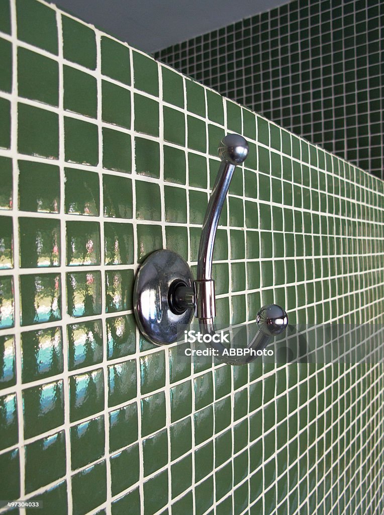 Metallic cloth hanger on a green wall Metallic cloth hanger on a green wall. Vertical format Close-up Stock Photo