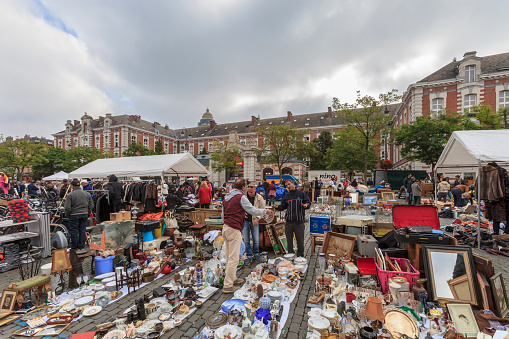 Brussels, Belgium - September 13, 2014: People stroll among the merchandise in the Flea Market in Place du Jeu de Balle, where one can find antiquities and collections everyday and all year round.