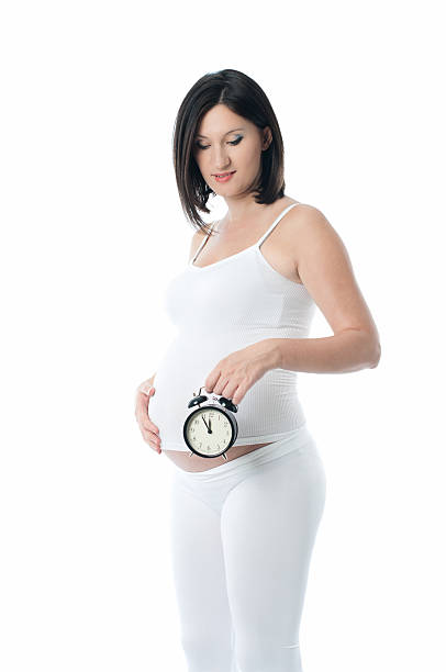 istock Pregnant woman holding a clock and wait for her time 497306604