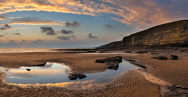 istock Stunning vibrant panorama sunset landscape over Dunraven Bay in 497307872