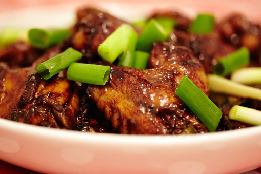 Closeup of asian caramel chicken wings, selective focus