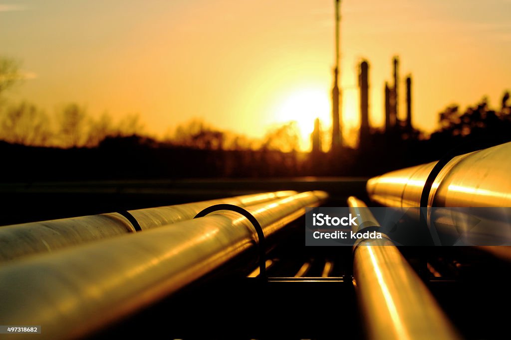 Golden pipes going to oil refinery Pipeline Stock Photo